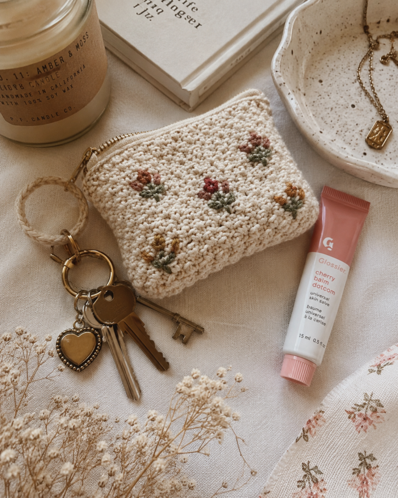 Finished mini crochet pouch styled with everyday accessories.